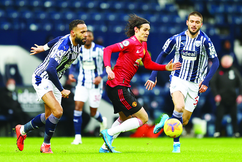 WEST BROMWICH: Manchester United's Uruguayan striker Edinson Cavani vies for the ball with West Bromwich Albion's English defender Kyle Bartley (left) at The Hawthorns stadium yesterday. - AFP n
