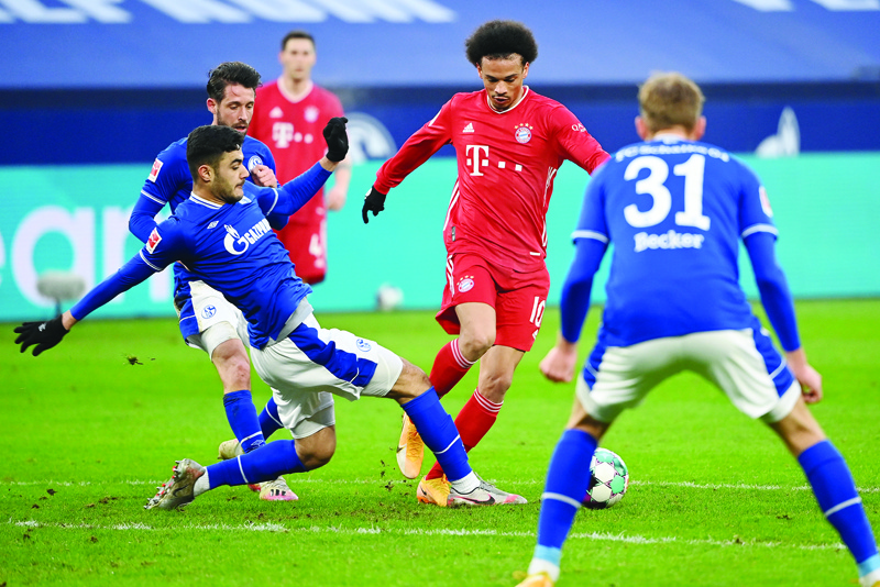 Schalke's Turkish defender Ozan Kabak and Bayern Munich's German midfielder Leroy Sane vie for the ball during the German first division Bundesliga football match Schalke 04 v FC Bayern Munich in Gelsenkirchen, western Germany, on January 24, 2021. (Photo by Ina FASSBENDER / various sources / AFP) / DFL REGULATIONS PROHIBIT ANY USE OF PHOTOGRAPHS AS IMAGE SEQUENCES AND/OR QUASI-VIDEO