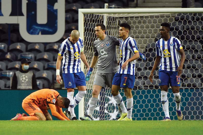 PORTO: Juventus' Portuguese forward Cristiano Ronaldo (left) reacts to his team's defeat at the end of the UEFA Champions League round of 16 first leg football match between Porto and Juventus at the Dragao stadium in Porto on Wednesday. - AFPn
