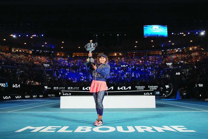 MELBOURNE: This hand out photo released by the Tennis Australia yesterday shows Japan's Naomi Osaka holds the Daphne Akhurst Memorial Cup trophy after her women's singles final match against Jennifer Brady of the US on day thirteen of the Australian Open tennis tournament in Melbourne. - AFPn