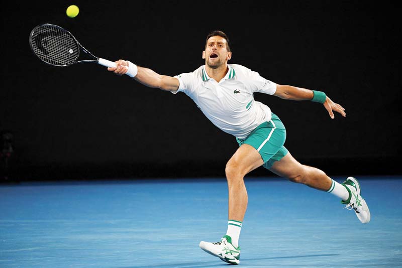 MELBOURNE: Serbia's Novak Djokovic hits a return against Canada's Milos Raonic during their men's singles match on day seven of the Australian Open tennis tournament in Melbourne yesterday. - AFPn
