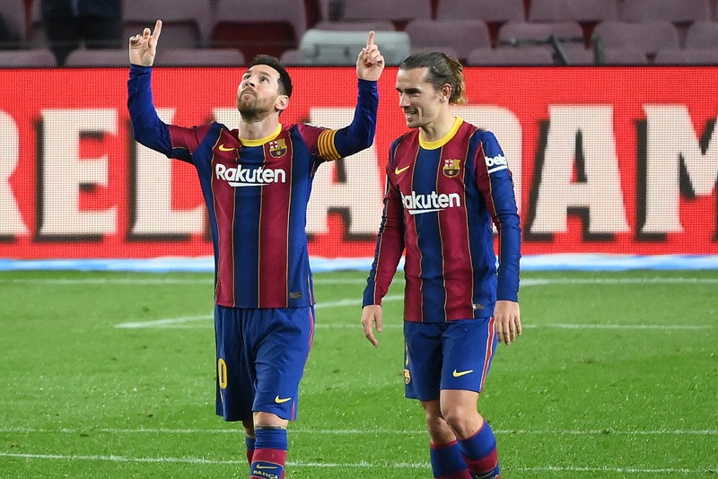 BARCELONA: Barcelona's Argentinian forward Lionel Messi (left) celebrates with Barcelona's French midfielder Antoine Griezmann after scoring a goal during the Spanish league football match between FC Barcelona and Deportivo Alaves at the Camp Nou stadium in Barcelona on February 13, 2021. - AFPn