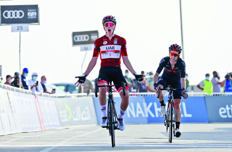 JEBEL HAFEET: UAE Team Emirates' Slovenian cyclist Tadej Pogacar celebrates upon crossing the finish line to win the third stage of the UAE Cycling Tour from Al-Ain to Jebel Hafeet yesterday. - AFPn