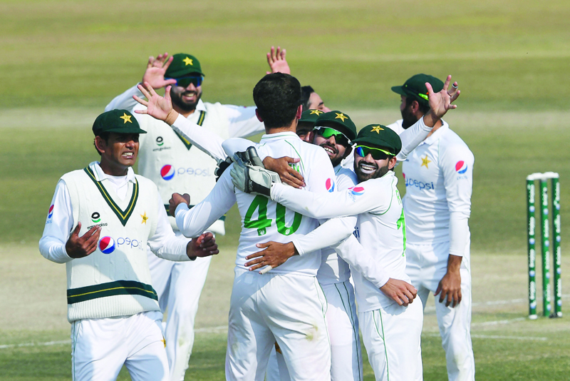 RAWALPINDI: Pakistan's players celebrate after the dismissal of South Africa's Keshav Maharaj during the fifth and final day of the second Test cricket match between Pakistan and South Africa at the Rawalpindi Cricket Stadium in Rawalpindi yesterday. - AFPn