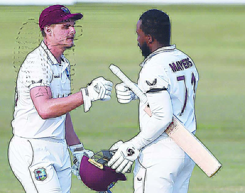 CHITTAGONG: West Indies' Kyle Mayers (right) celebrates scoring a double century with (200 runs) with teammate Joshua Da Silva during the fifth day of the first cricket Test match between Bangladesh and West Indies at the Zohur Ahmed Chowdhury Stadium in Chittagong yesterday. - AFPn