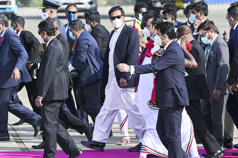 COLOMBO: Pakistan's Prime Minister Imran Khan (center) walks with his Sri Lankan counterpart Mahinda Rajapakse (center right in white) at Bandaranaike International Airport in Katunayake yesterday after  Khan arrived for a two-day official visit to Sri Lanka. - AFPn