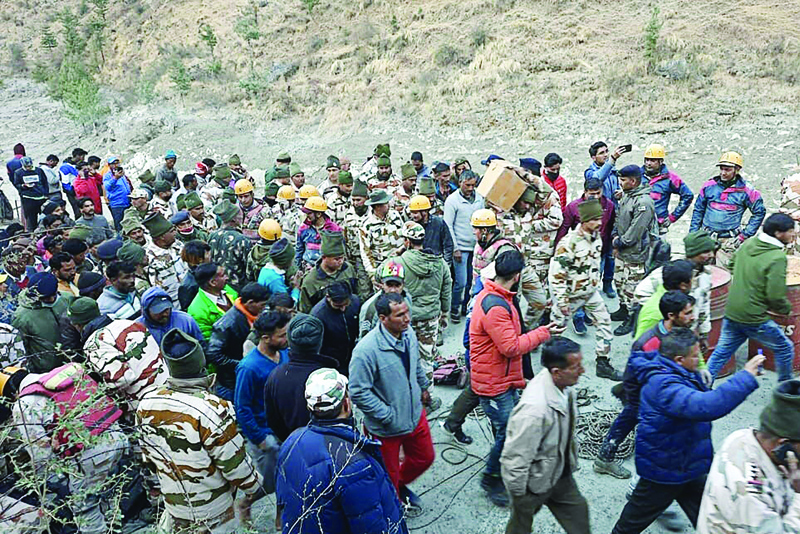 Onlookers and members of the Indo-Tibetan Border Police (ITBP) during a rescue operation after a broken glacier caused a major river surge that swept away bridges and roads, at Reni village in Chamoli district of Uttarakhand. - AFPn