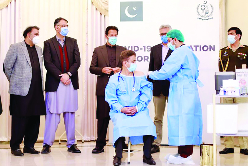 ISLAMABAD: Pakistani Prime Minister Imran Khan witnesses the first Chinese-made COVID-19 vaccine being administered to a frontline health worker on Tuesday. – AFP n