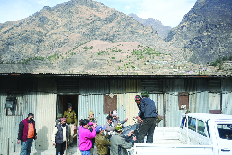 Relatives load on a vehicle the body of a victim recovered from Raini village, outside a temporary morgue in Tapovan of Chamoli district yesterday following a flash flood thought to have been caused when a glacier burst on February 7. -- AFPn