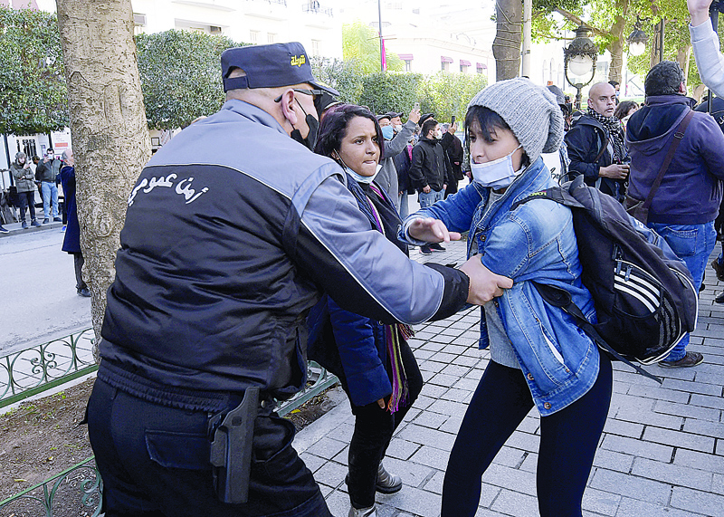 TUNIS: Tunisian police detain a protester during an anti-government demonstration in the capital Tunis.-AFPn