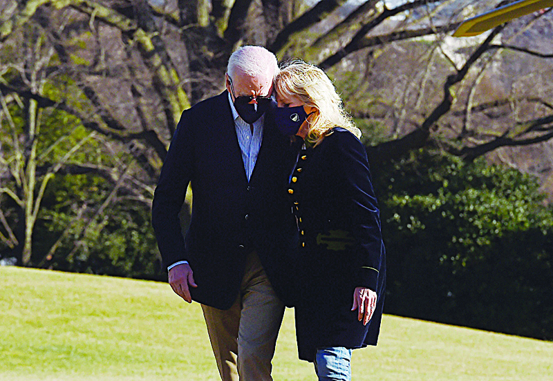 WASHINGTON: US President Joe Biden and First Lady Jill Biden walk across the South Lawn upon return from Camp David, Maryland, to the White House in Washington, DC.-AFP n