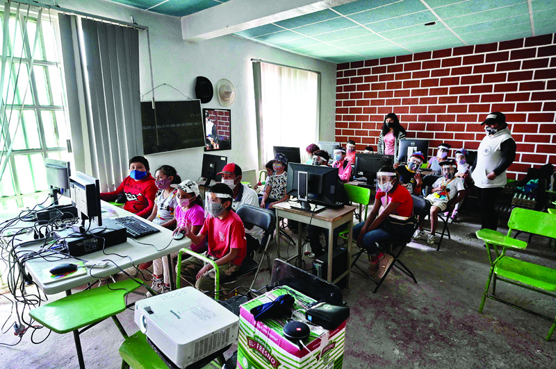 Santa Maria Chimalhuacan, Mexico: Children attend a computer science class at the Escalerillas neighborhood in Chimalhuacan, Mexico state, Mexico.-AFP n