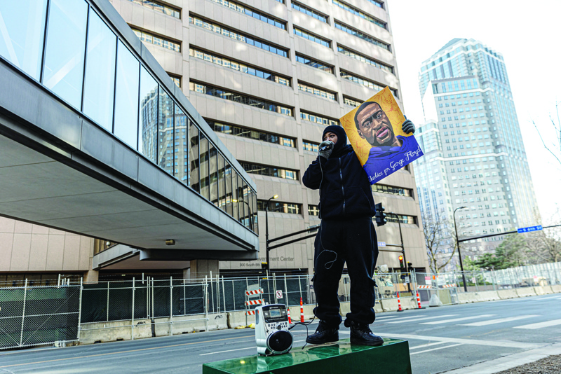MINNEAPOLIS: A demonstrator holds a portrait of George Floyd outside the Hennepin County Government Center on Tuesday in Minneapolis, Minnesota. - AFPn
