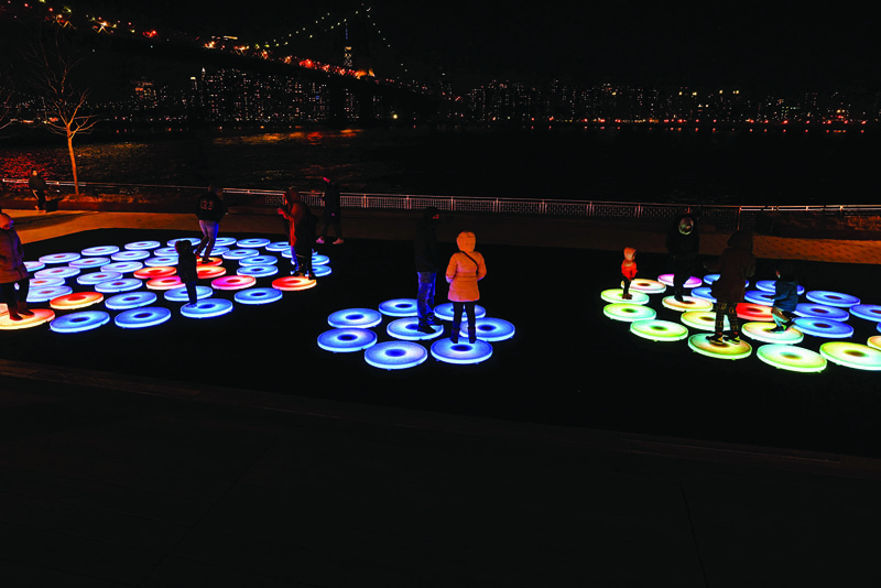 People walk on a new public art installation at Domino Park in Brooklyn on March 15, 2021 in New York City.-AFP n