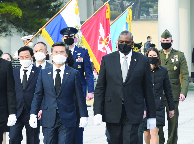SEOUL: US Defense Secretary Lloyd Austin (right) and South Korean Defense Minister Suh Wook (second left) walk during their visit to the National Cemetery in Seoul yesterday.-AFPn