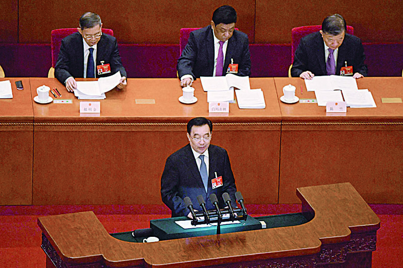 BEIJING: Wang Chen (center), vice chairman of the National People's Congress (NPC), delivers a speech during the opening ceremony of the National People's Congress (NPC) at the Great Hall of the People in Beijing.-AFP n