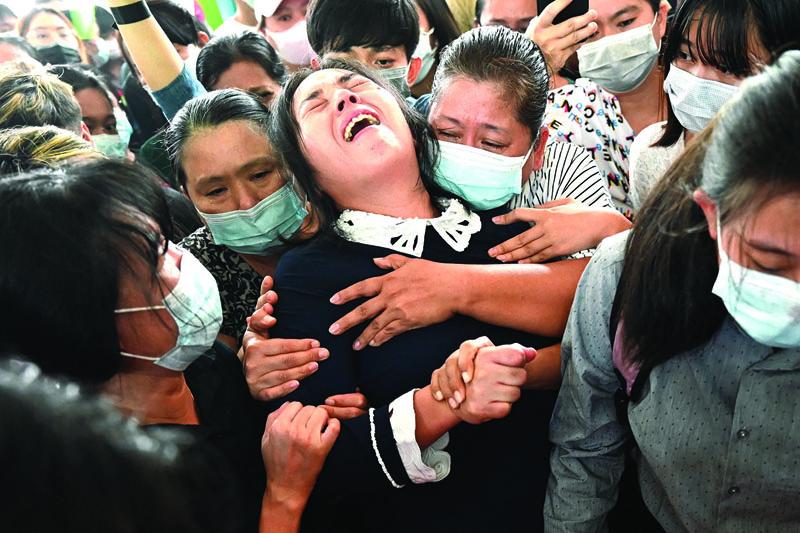 YANGON: The mother (center) of Khant Nyar Hein reacts at his funeral in Yangon on Tuesday after the first year medical student was shot dead during a crackdown by security forces on protesters taking part in a demonstration against the military coup. ? AFPn