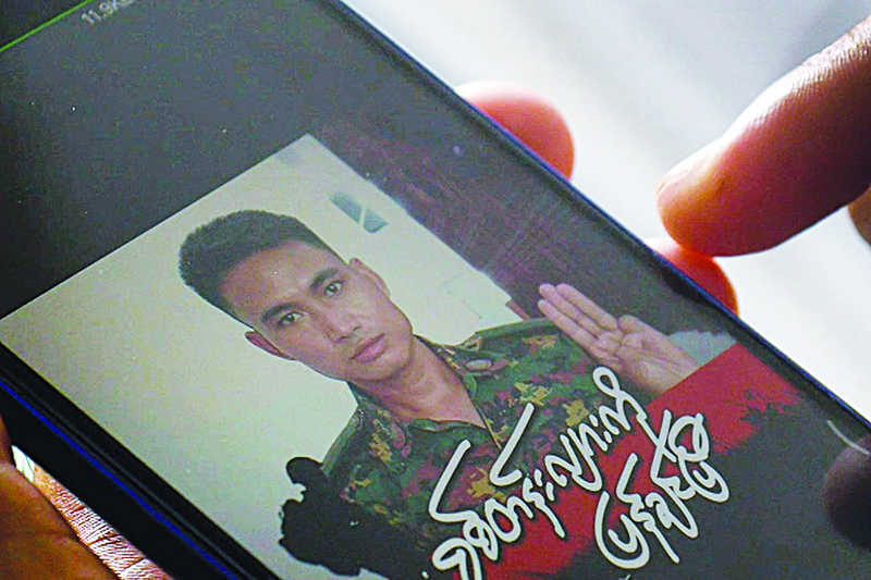 YANGON: This screengrab shows Shing Ling, a former Myanmar soldier who deserted the military to join the democracy movement in the aftermath of the military coup, looking at his Facebook profile showing his picture wearing a military uniform.—AFP n