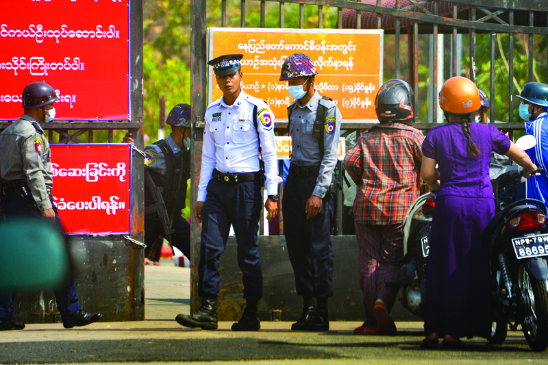 NAYPYIDAW: Police inspect the identification card of motorists entering Zabuthiri township court in Naypyidaw yesterday.-AFPn