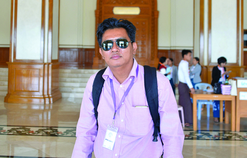 In this file photo taken on January 27, 2020 shows Aung Thura, a BBC News Burmese journalist, posing for a photo during his coverage of a Myanmar Parliament meeting in Naypyidaw. - AFPn