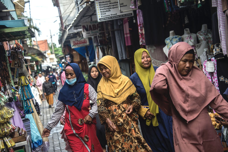 SURABAYA: This picture taken on March 17, 2021 shows women wearing hijabs shopping at a market in Surabaya. -AFPn