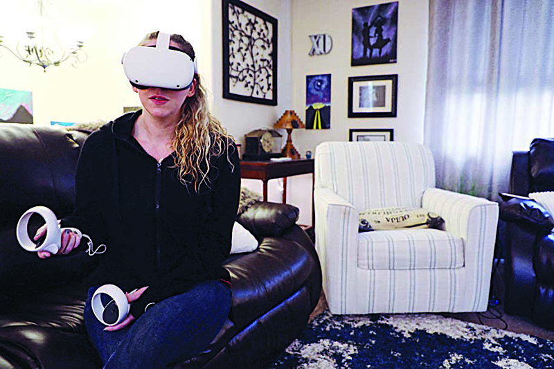 PORTLAND: Amy Erdt, a community leader in the virtual reality space, sits in her living room and travels to foreign cities virtually using her Oculus headset on March 19, 2021. - AFP