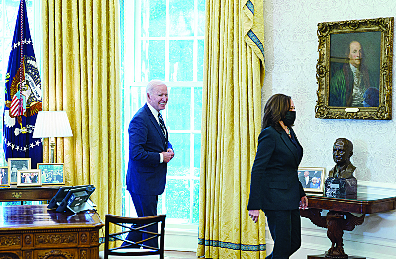 WASHINGTON: US President Joe Biden and Vice President Kamala Harris depart after US President Joe Biden signed the American Rescue Plan on March 11, 2021, in the Oval Office of the White House in Washington, DC. - AFPn