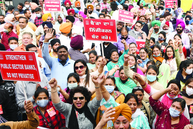 AMRITSAR: Banks' employees take part in a protest during a two-day nationwide bank strike in Amritsar yesterday.-AFPn