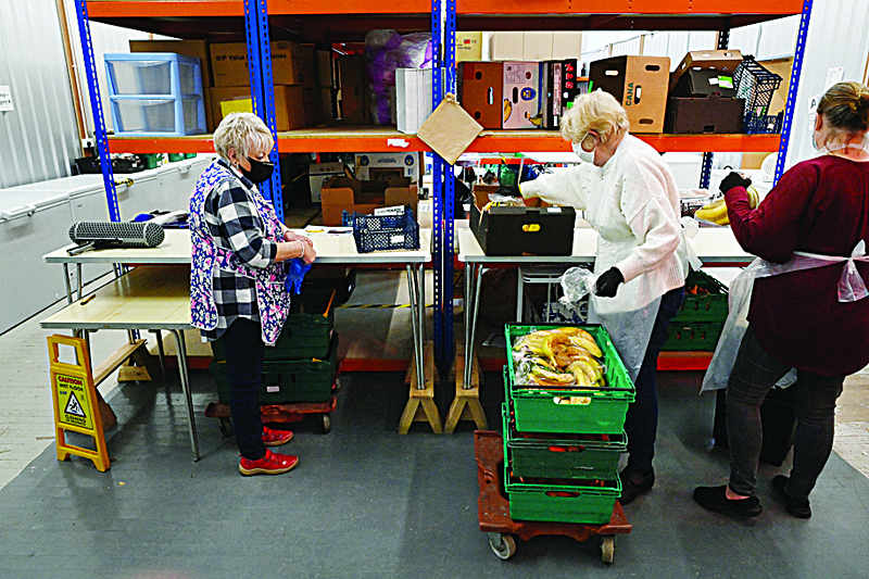 BACKPOOL, UK: Volunteers sort food at Blackpool Food Bank in Blackpool, north west England.  In Britain's most deprived areas, such as seaside resort Blackpool in northwest England, the coronavirus pandemic has worsened the financial plight of its most vulnerable resident. - AFPn