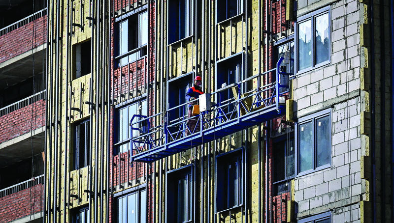 MOSCOW: A laborer works at a housing construction site of Granelle, a Moscow-based developer, in southwest Moscow. - AFPn