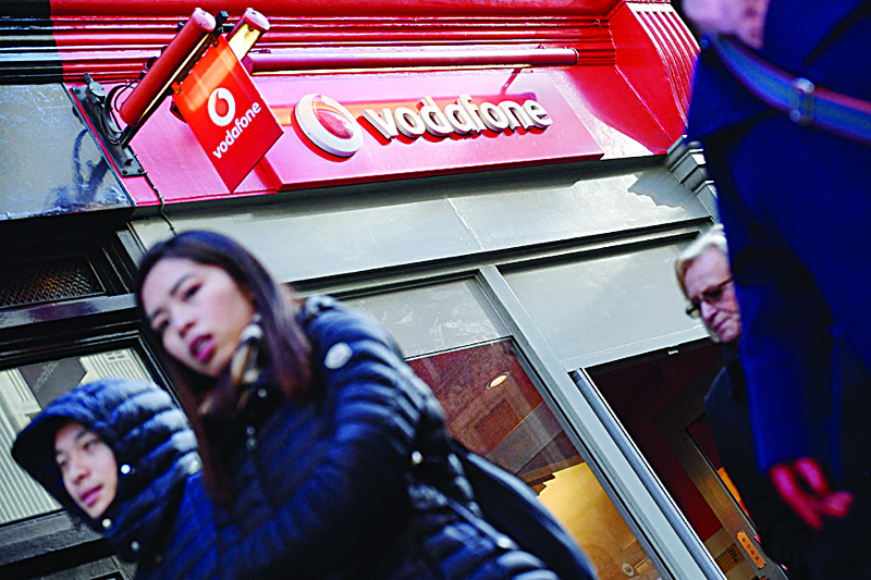 LONDON: The logo of British mobile phone giant Vodafone welcomes visitors at their retail shop in central London. Vodafone yesterday announced German stock market flotation of its towers business, valuing the unit at up to 14.7 billion euros ($17.4 billion). - AFPn