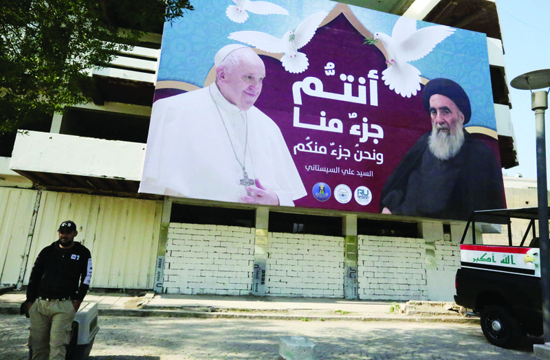 BAGHDAD: A giant billboard bears portraits of Pope Francis and Grand Ayatollah Ali Sistani in Baghdad yesterday ahead of the first-ever papal visit to Iraq.-AFP n