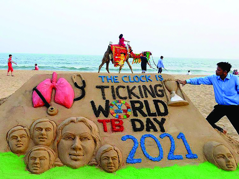PURI: Artist Manas Sahoo makes a sand art to observe 'World TB Day', in Puri, India, on Tuesday.n