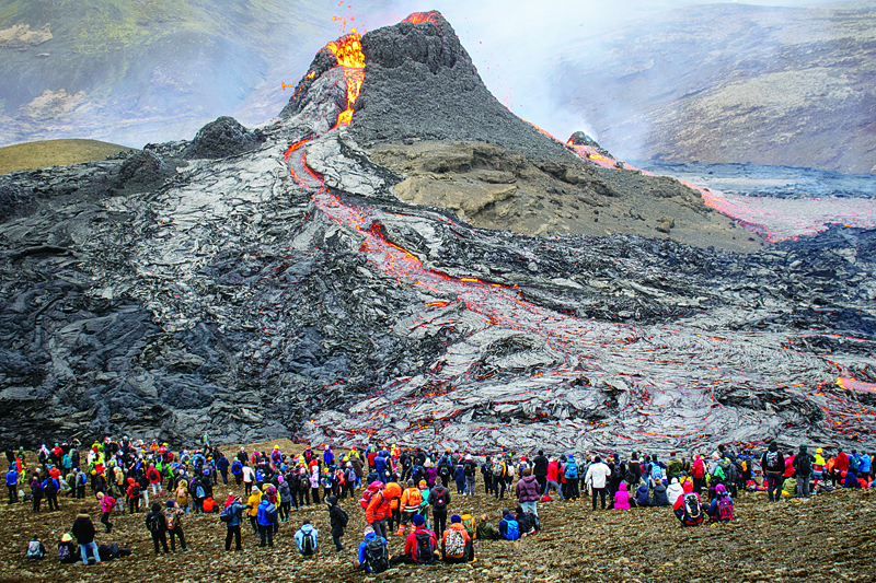 REYKJAVIK, Iceland: Sunday hikers look at the lava flowing from the erupting Fagradalsfjall volcano some 40 km west of the Icelandic capital Reykjavik. - AFPn
