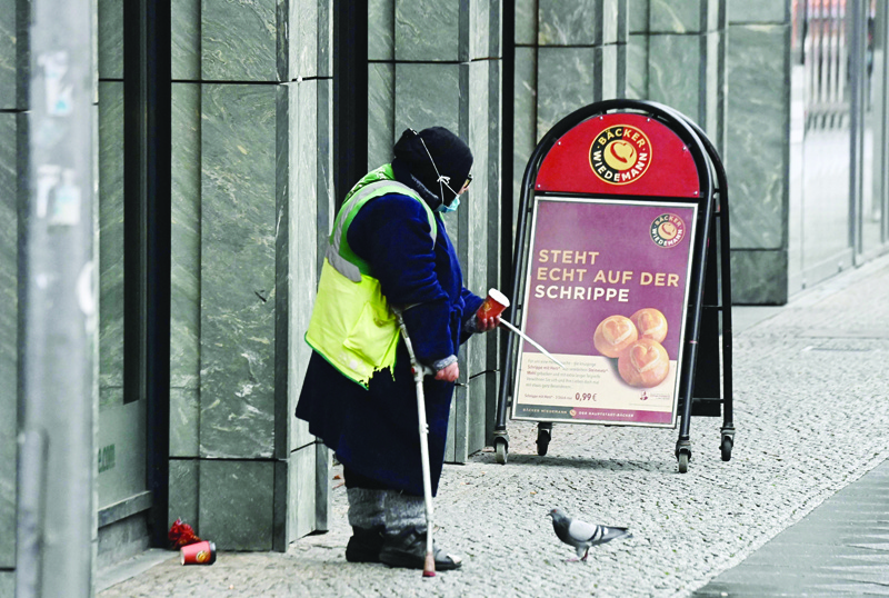 BERLIN: In this file photo a homeless woman begs for coins at Berlin's Friedrichstrasse, during the ongoing novel coronavirus pandemic.-AFP n