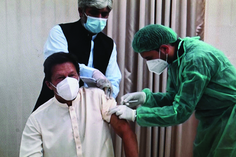 ISLAMABAD: Image grab shows Pakistani Prime Minister Imran Khan receiving a dose of the Chinese-made Sinopharm vaccine against COVID-19 coronavirus at the Prime Minister House on March 18, 2021. - AFP  n