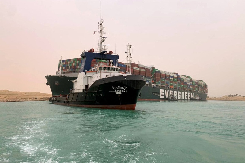ISMAILIA: Taiwan-owned MV Ever Given (Evergreen) vessel is lodged sideways yesterday, impeding all traffic across the Suez Canal. - AFP  n
