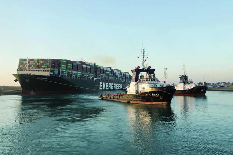 ISMAILIA, Egypt: Tugboats yesterday pull the Panama-flagged MV 'Ever Given' that was lodged sideways across the Suez Canal. - AFP  n