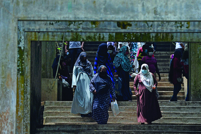 COLOMBO: Burqa-clad Muslim women climb down a flight of stairs at a zoological park yesterday. - AFP n