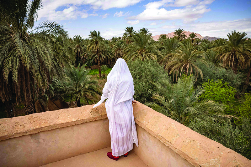 FIGUIG, Morocco: A woman stands at a viewpoint overlooking this oasis town on the border with Algeria on March 19, 2021. - AFP n