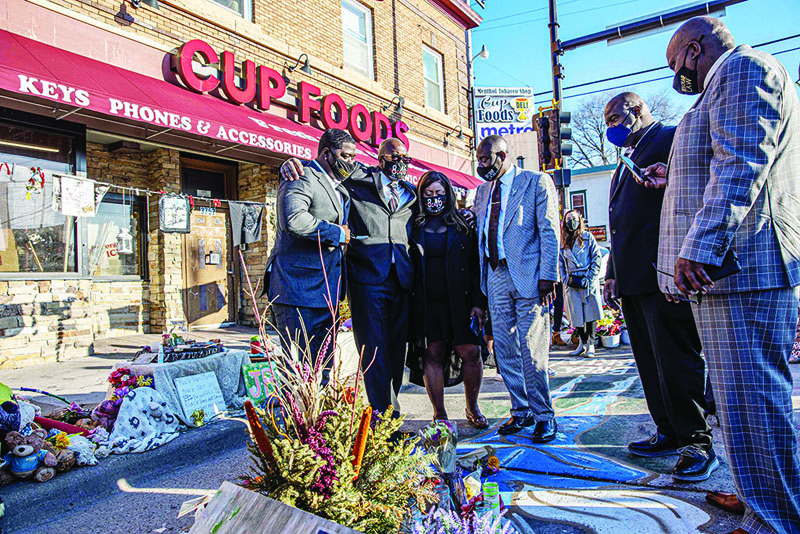 MINNEAPOLIS: George Floyd's family and their lawyer visit a memorial at the site where Floyd died while being arrested, after attending a press conference on Friday. - AFP n
