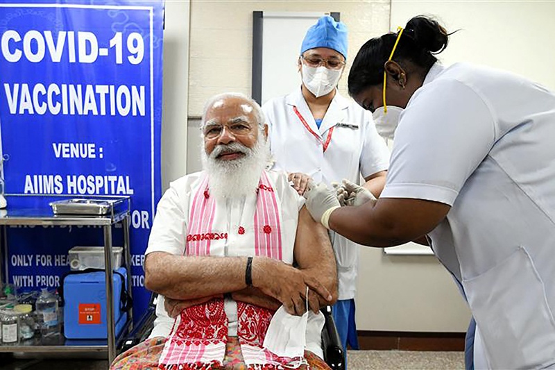 NEW DELHI: A health worker inoculates India's Prime Minister Narendra Modi with a COVID-19 vaccine at AIIMS hospital yesterday. - AFP n