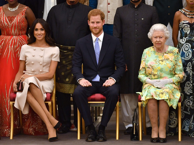 LONDON: In this file photo taken on June 26, 2018, Meghan, Duchess of Sussex, Britain's Prince Harry, Duke of Sussex and Britain's Queen Elizabeth II pose for a picture during the Queen's Young Leaders Awards Ceremony at Buckingham Palace. – AFP  n