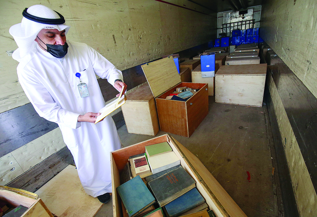 KUWAIT: Information Ministry official Essam Al-Said inspects boxes in the back of a truck containing Kuwaiti archives seized during the Iraqi invasion in 1990, after their return by Iraqi authorities yesterday. - Photos by Yasser Al-Zayyatn