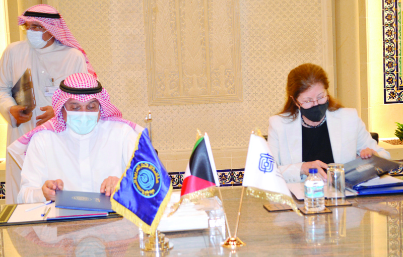 KUWAIT: OAPEC secretary general Ali bin Sabt (left) and KISR Director General Dr Samira Sayyed Omar sign the agreement. - KUNAn