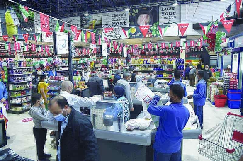KUWAIT: People shop at a co-op society yesterday, one day before Kuwait was set to start a daily partial curfew following a sharp increase in COVID-19 cases. - Photo by Fouad Al-Shaikhn