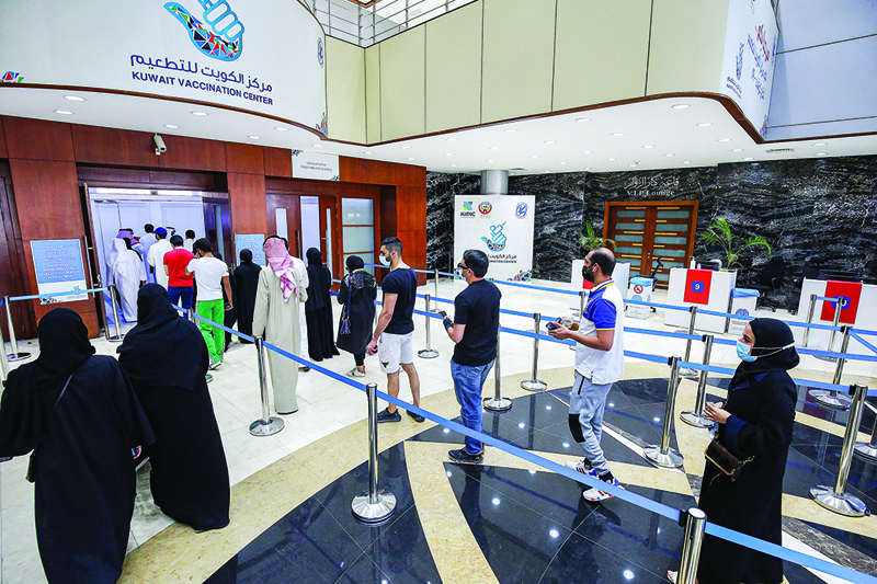 KUWAIT: People queue as they wait their turn to receive a dose of COVID-19 vaccine at the make-shift vaccination center at the Kuwait International Fairground in the Mishref on March 21, 2021. - Photo by Yasser Al-Zayyatn