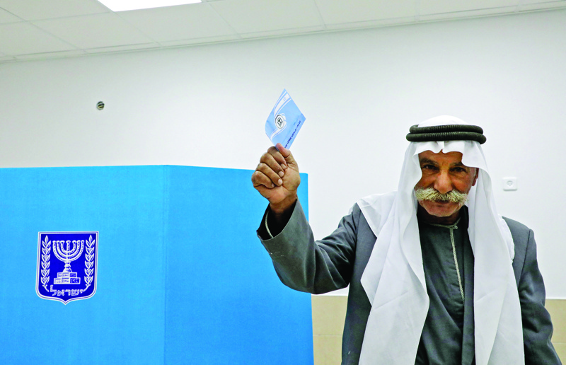 An Israeli Bedouin casts his ballot yesterday in the Bedouin town of Rahat on the fourth national election in two years. - AFPnn