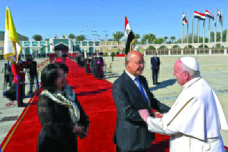 BAGHDAD : A handout picture shows Iraq's President Barham Saleh (center) and his wife Sarbagh (left) bidding farewell to Pope Francis (right) during the farewell ceremony at the conclusion of the pontiff's visit to Iraq, at the capital's Baghdad International Airport.-AFP n