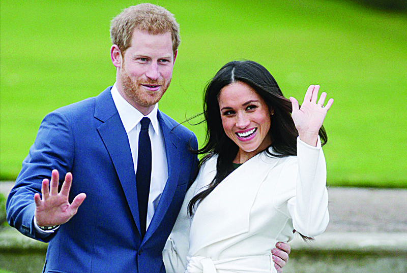 In this file photo Britain's Prince Harry and his fiancée US actress Meghan Markle pose for a photograph in the Sunken Garden at Kensington Palace in west London.-AFP n